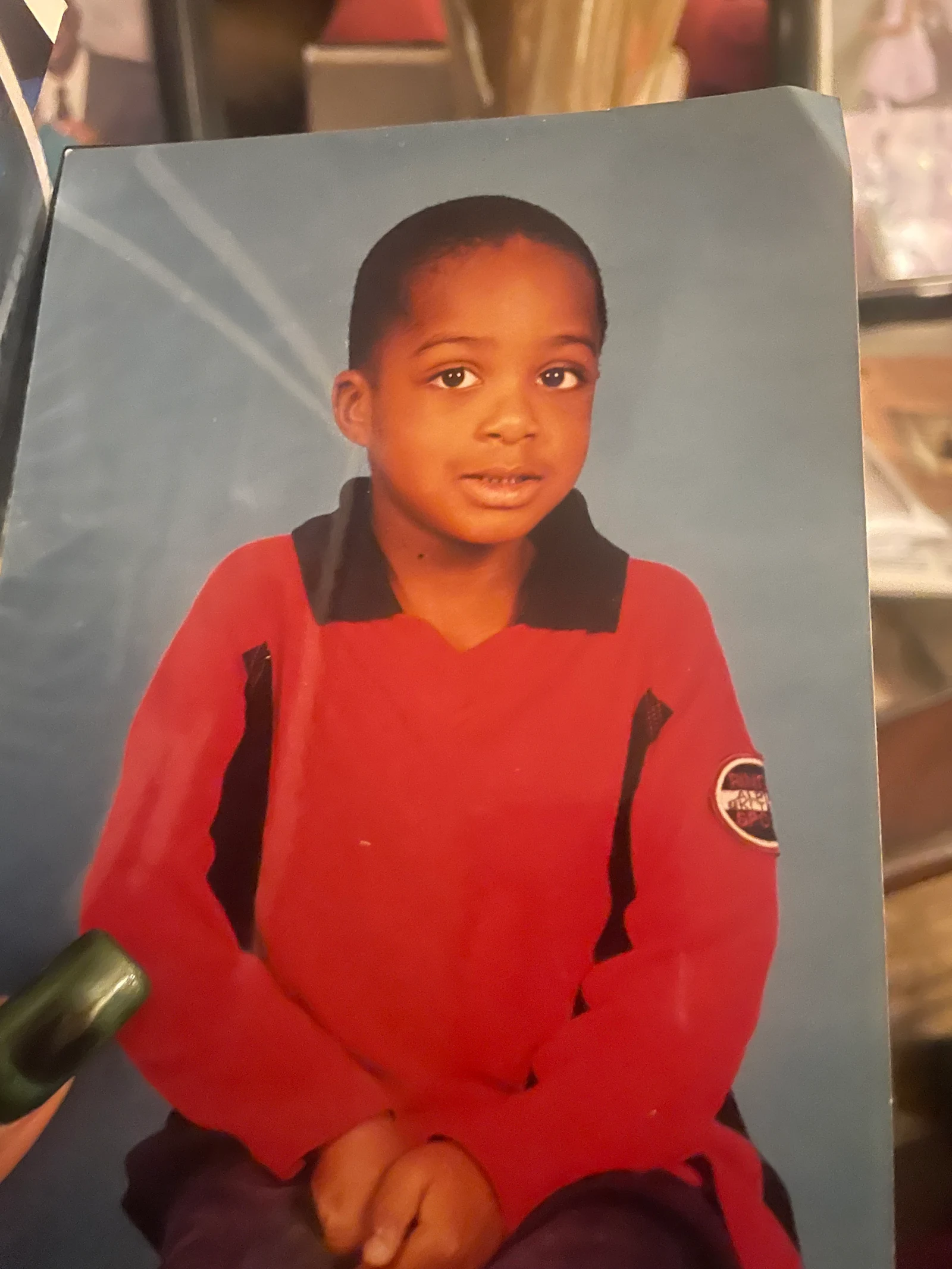Original child portrait in a red polo used as a reference for a GPT Image 2.5 edit